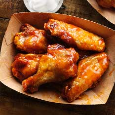 Basket of bone in chicken wings tossed in bbq sauce served at the Rockin Chicken Shack restaurant in Wisconsin Dells.