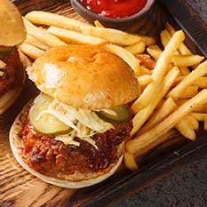 Two fried and breaded chicken sandwiches topped with pickles and a side of French fries served at the Rockin Chicken Shack restaurant in Wisconsin Dells.