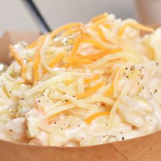 Bowl of creamy golden homemade mac and cheese served at the Rockin Chicken Shack restaurant in Wisconsin Dells.